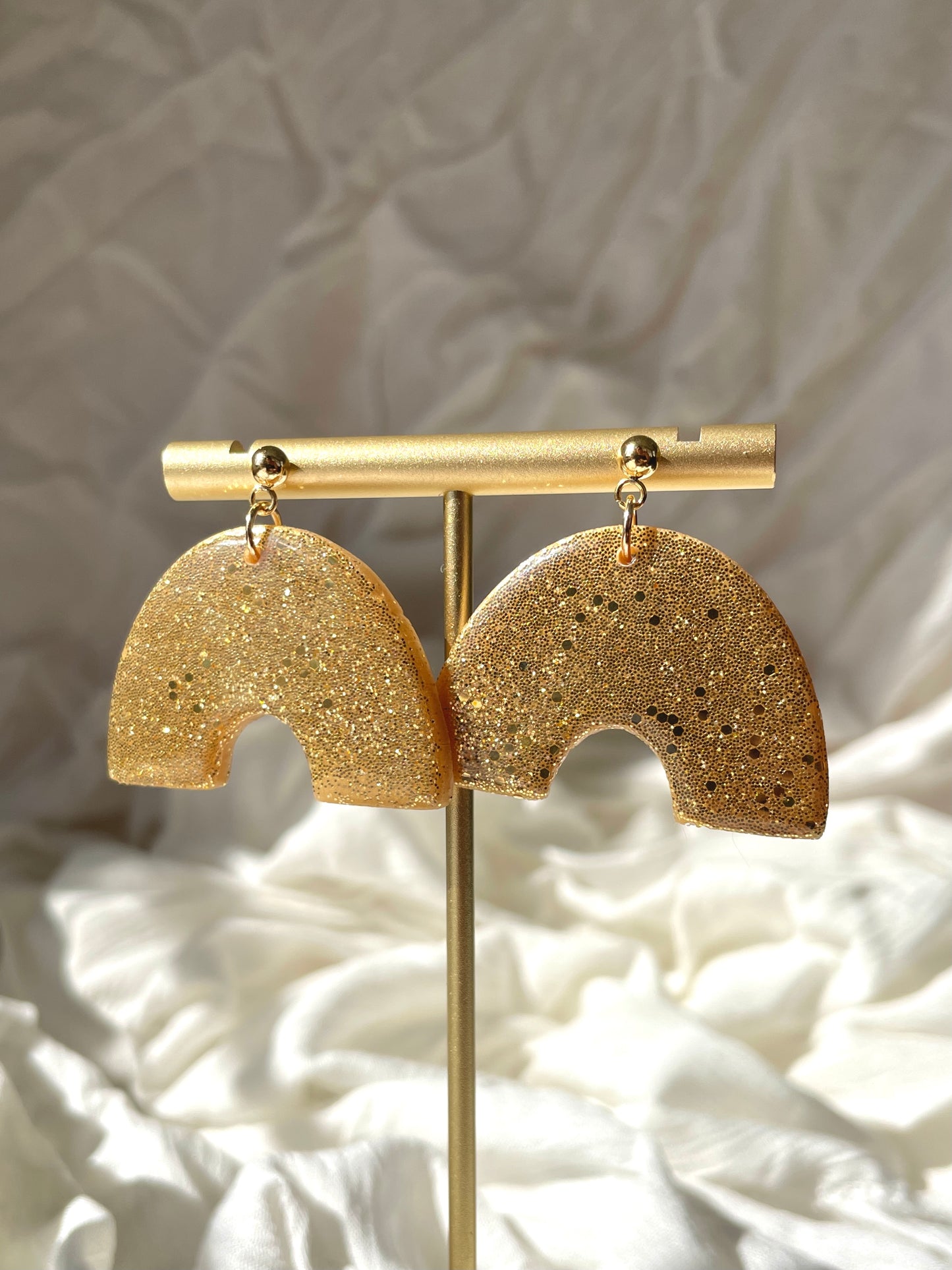 Gold glitter rainbow shaped earrings